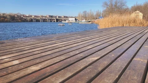 Wooden Board Pier by a River - Vertical Tilt Footage of an Urban Landscape Stock Footage
