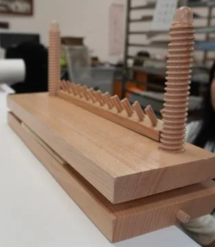 Wooden bookbinding press on the table. Stock Photos