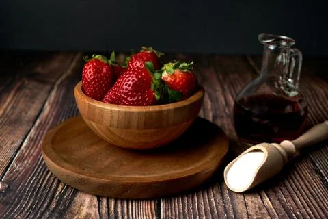 Wooden bowl with fresh red strawberries with sugar and vinegar for its prepar Stock Photos