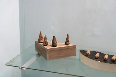 A wooden box with five small objects inside. in Chennai Stock Photos