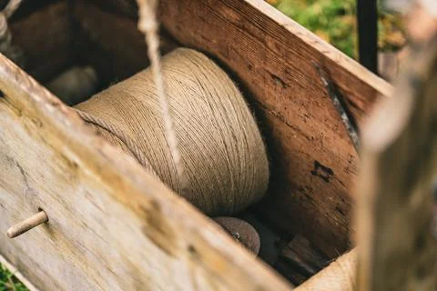 A wooden box with a spool of thread inside Stock Photos