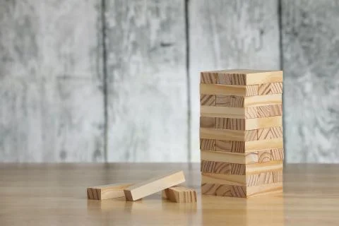 Wooden bricks on a table. Tower construction game. Stock Photos