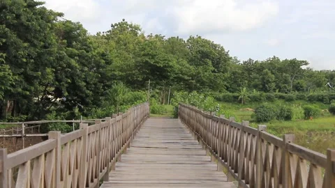 Wooden Bridge with a background of cloudy blue sky. Located in Boyolali Video stock 295909109