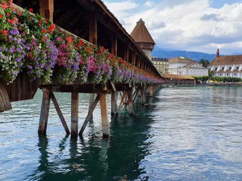 Wooden bridge with coloured flowers in Luzern switzerland Stock Photos