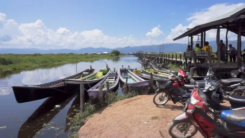 Wooden bridge with motorbikes on Inle lake, Burma Stock Footage