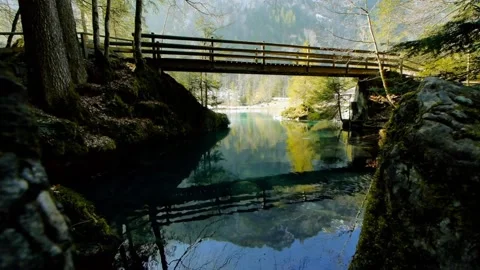 Wooden bridge with mountain river reflection. Stock Footage 306648097