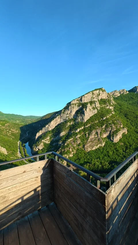 Wooden bridge opens to rugged mountain vista. Sicevo Gorge, Serbia. Vertical Vídeos de archivo 337058007