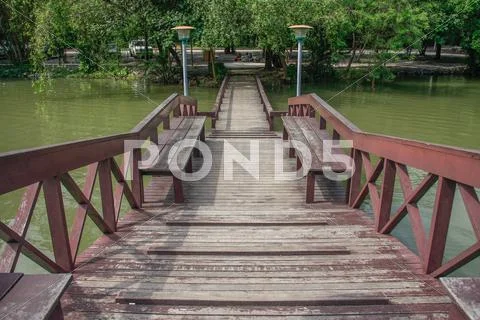 Wooden bridge over pond Stock Photos