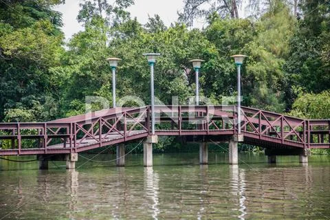 Wooden bridge over pond Stock Photos