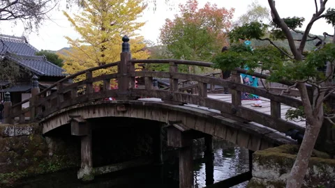 A wooden bridge over a quiet stream in  Edo Wonderland , Nikko, Japan Stock Footage 335583336