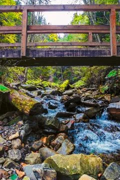 Wooden bridge over the river rain in the autumn morning - Carpathian Mountain Stock Photos