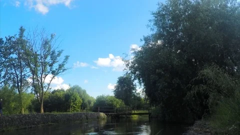Wooden Bridge over the river on summer day in park timelapse Stock Footage