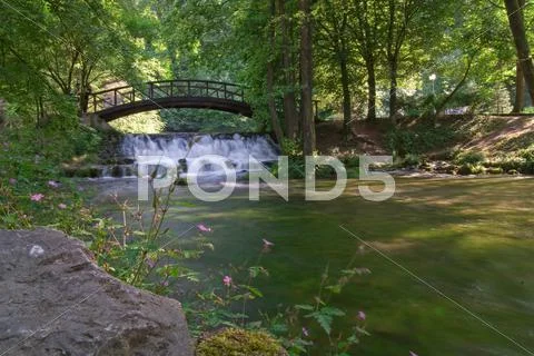Wooden bring over small waterfall Stock Photos