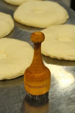 Wooden brush for greasing bread when baking on the background of crumpets, co Stock Photos