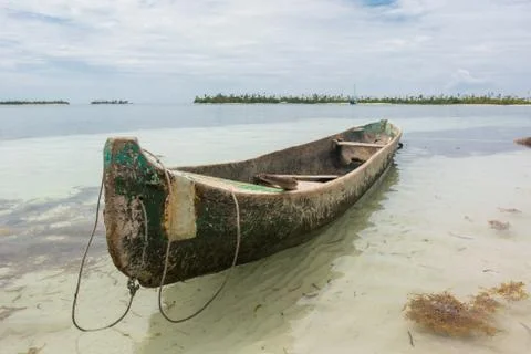 Wooden canoe traditional boat stranded in beach shoreline in Guna Yala San Blas Stock Photos