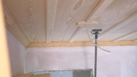 Wooden ceiling installation process using support pole, home improvement co.. Stock Footage 333154580