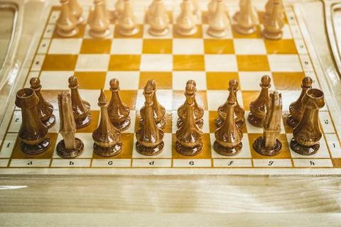 Wooden chess on the board, the beginning of the game 스톡 사진