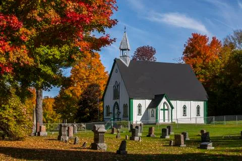  A wooden church and cemetery with bright autumn colors Stock Photos