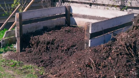 Wooden compost bin with dark compost and organic matter in garden Stock Footage 339418150