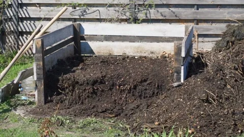 Wooden compost bin with dark decomposed vermicompost in garden Stock Footage 341406839