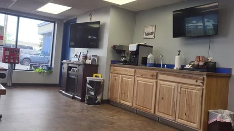 Wooden counters line a clean, quiet repair shop waiting room, Pan Rt to Left 스톡 동영상 340236984