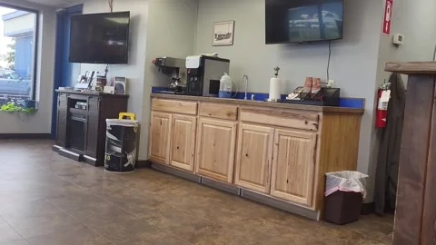 Wooden counters line a clean, quiet auto repair breakroom, waiting room Stock Footage 340236990