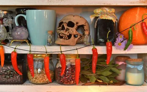 Wooden counters with witch ritual objects, cup, old bottles of herbs and poti Stock Photos