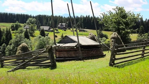 Wooden country house, green lawn and blue sky Stock Footage