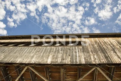 Wooden covered bridge against blue skies Stock Photos