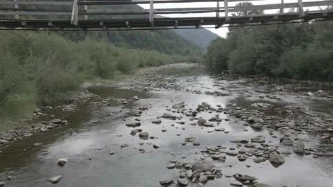 Wooden crossing of the river span under the bridge view from the drone 4k Stock Footage 138864656