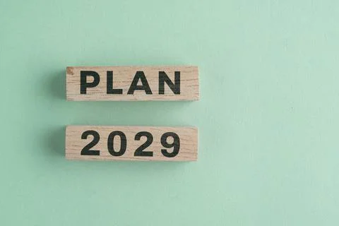 Wooden cube with 2029 PLAN text isolated on a paper background, representin.. Stock Photos