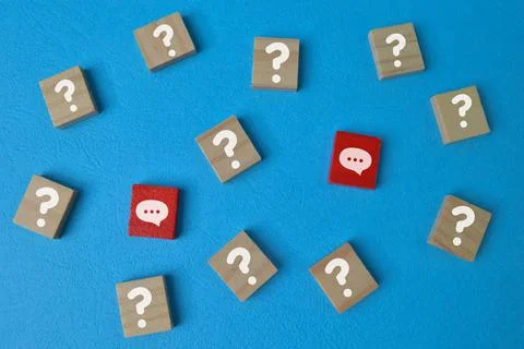 Wooden cube blocks with question mark and chat symbols. Q&amp;a concept Stock Photos