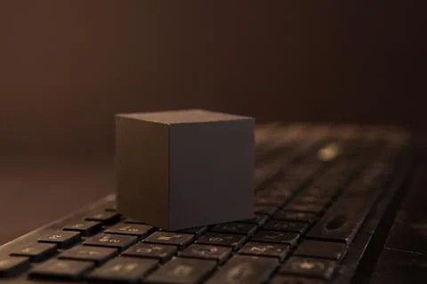 Wooden cube on a computer keyboard. Selective focus. Stock Photos