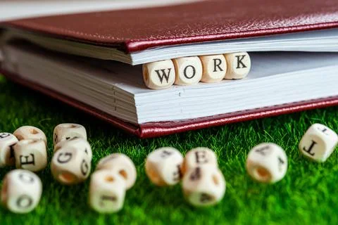 Wooden cube with letters WORK in notepad - job search and online application Foto stock