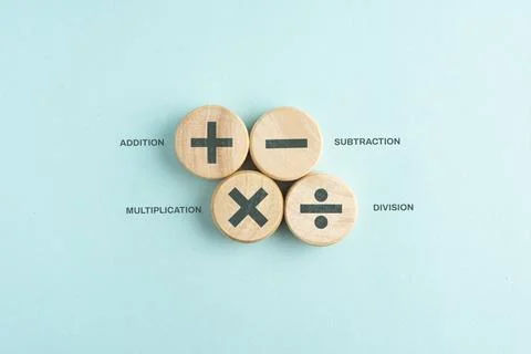 Wooden cube with plus, minus, multiplication and division symbols. Four Bas.. Stock Photos