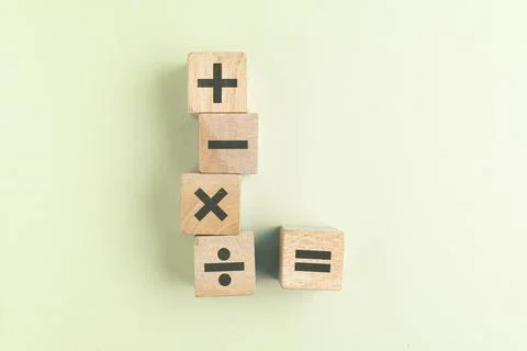 Wooden cube with plus, minus, multiplication and division symbols. Four Bas.. Stock Photos