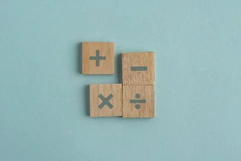 Wooden cube with plus, minus, multiplication and division symbols. Four Bas.. Stock Photos