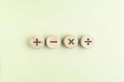 Wooden cube with plus, minus, multiplication and division symbols. Four Bas.. Stock Photos