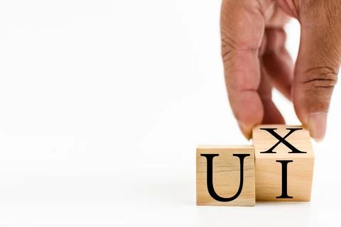A wooden cube on a white table with text UI, UX. Concept of development and.. Stock Photos