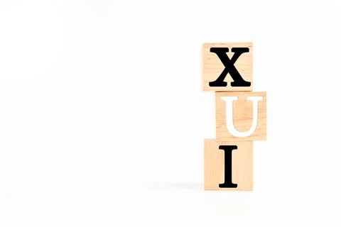 The Wooden cube on a white table with text UX, UI. Concept of development a.. Stock Photos