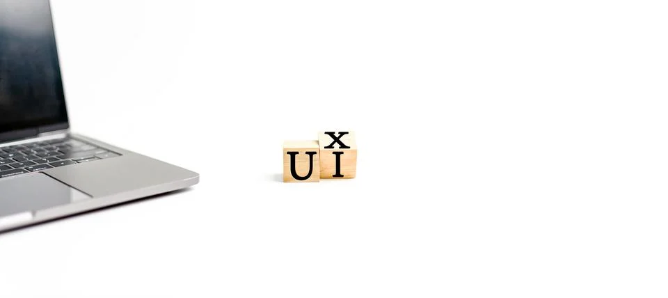 Wooden cube on a white table with text UX, UI. Concept of development and d.. Stock Photos