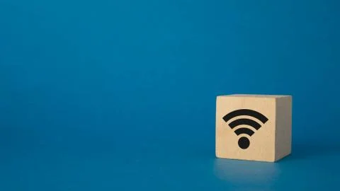 Wooden cube with wi-fi pattern on a blue background Foto stock