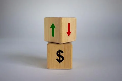 Wooden cubes changes the direction of an arrow symbolizing that the dollar ar Stock Photos