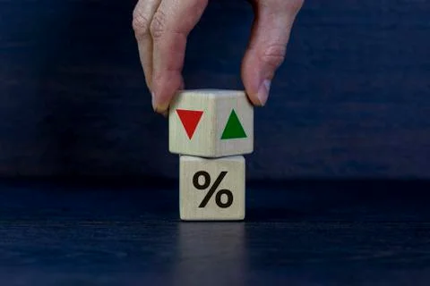 Wooden cubes changes the direction of an arrow symbolizing that the interest  Stock Photos