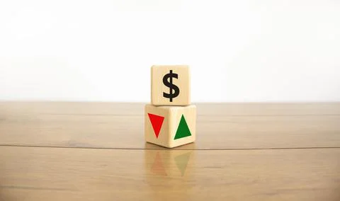 Wooden cubes changes the direction of an arrow symbolizing that the dollar in Stock Photos