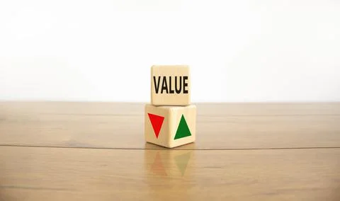 Wooden cubes changes the direction of an arrow symbolizing that the value int Stock Photos