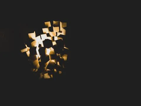 Wooden cubes stack with light shines in the dark 스톡 사진