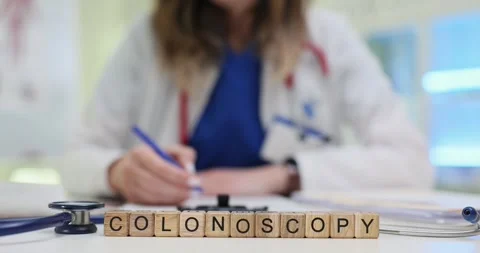 Wooden cubes write Colonoscopy word near stethoscope on desk Stock Footage 313293010