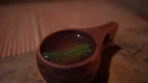 Wooden cup of forest tea, pine needles in a cup, hot drink Stock Footage 242864247