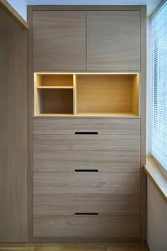 Wooden cupboard with drawers, empty shelves and LED lights. Modern furniture Stock Photos
